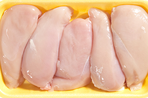 Raw chicken in container