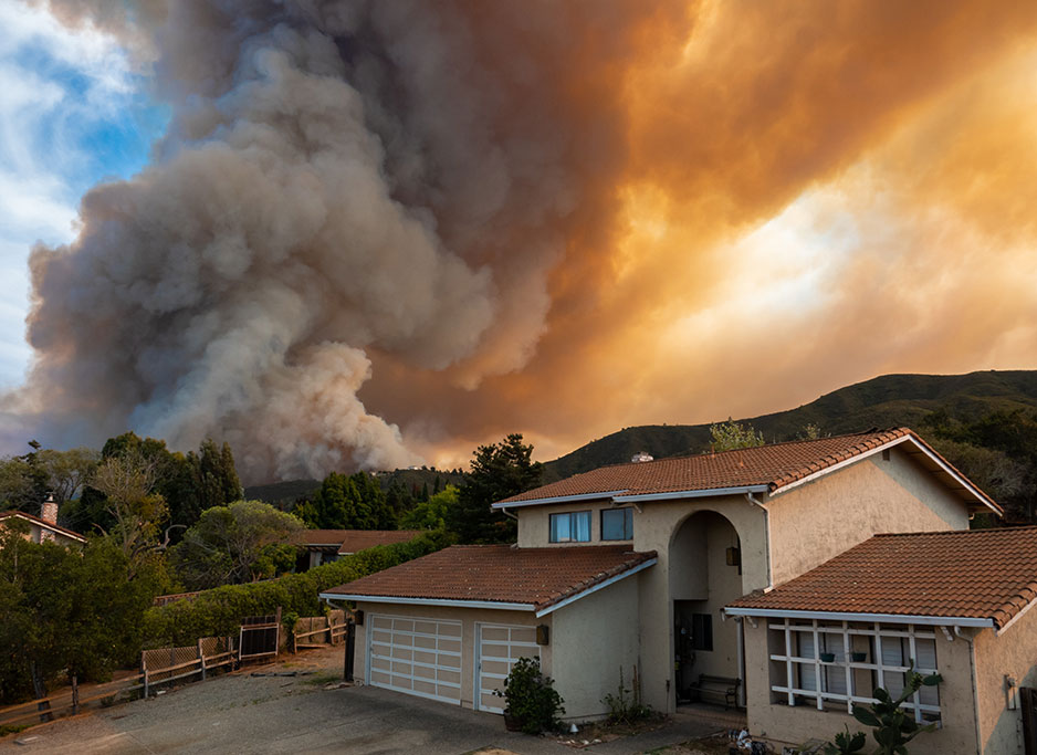 Wildfire smoke behind a home.