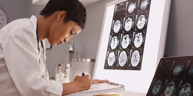 Researcher reads x-ray results of a brain