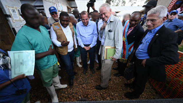 Members of the U.S. delegation to the Democratic Republic of the Congo speak with a boy who had just been told he no longer had Ebola in Butembo, Democratic Republic of the Congo