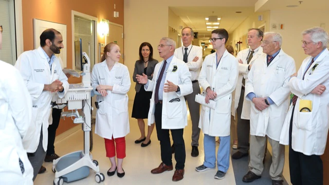 National Institute of Allergy and Infectious Diseases (NIAID) Director Anthony Fauci and NIAID Deputy Director for Clinical Research and Special Projects H. Clifford Lance speaking with a group of colleagues at NIH