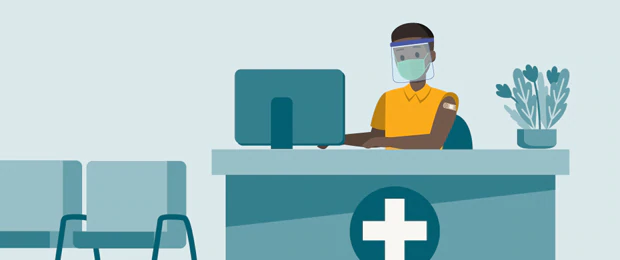 An illustration of a doctor’s office reception area with empty waiting room chairs. An employee is sitting behind a reception desk in front of a computer wearing a face mask and face shield. The employee has a band aid on his upper arm.