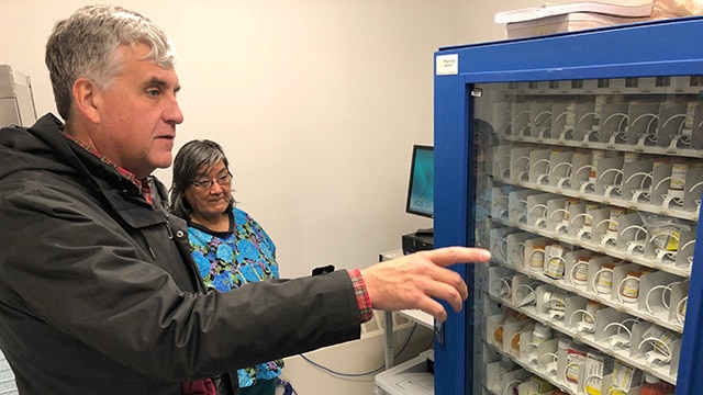 Deputy Secretary Eric Hargan looks at a medicine "vending machine"
