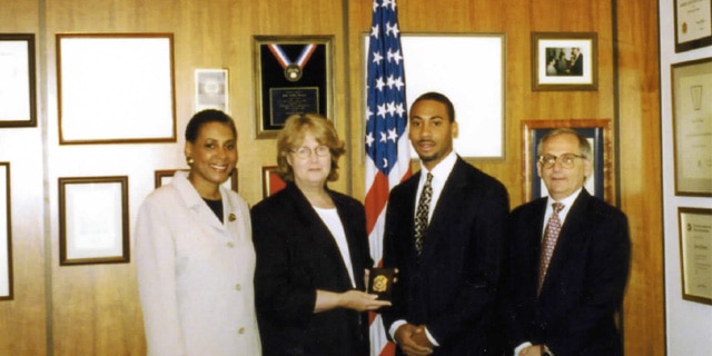 Derrick Jackson is sworn in as a special agent. Carolyn Jackson (far left), June Gibbs Brown (middle left), Derrick Jackson (middle right), Jack Hartwig (far right).