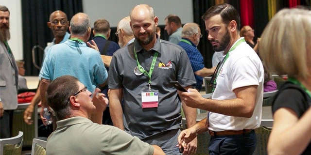 David Rice (far right) interacts with colleagues at an event.