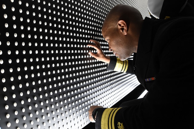Surgeon General looks at the faces of victims of the wall.