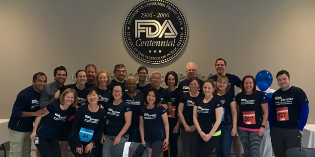Mike Sauers (back/right) poses with other staff members of FDA's Office of Prescription Drug Promotion's (OPDP). Photo Credit: FDA.