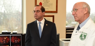 Alex Azar and person in doctor's jacket