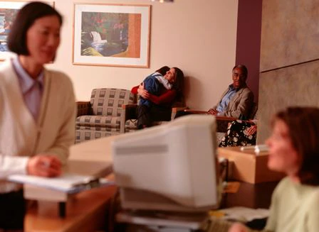 Woman standing at clinic reception desk
