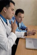 Health care professionals using laptop