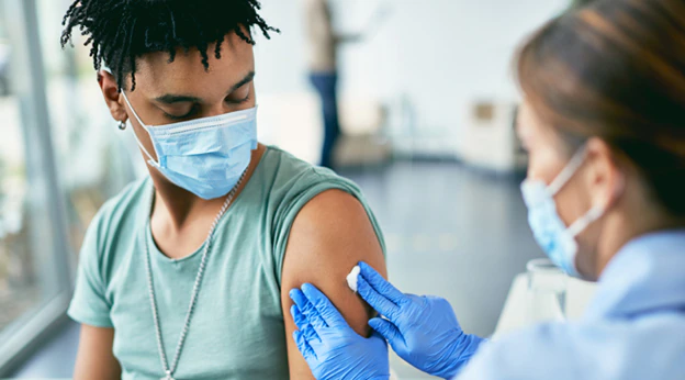 Young man getting vaccinated against COVID-19.