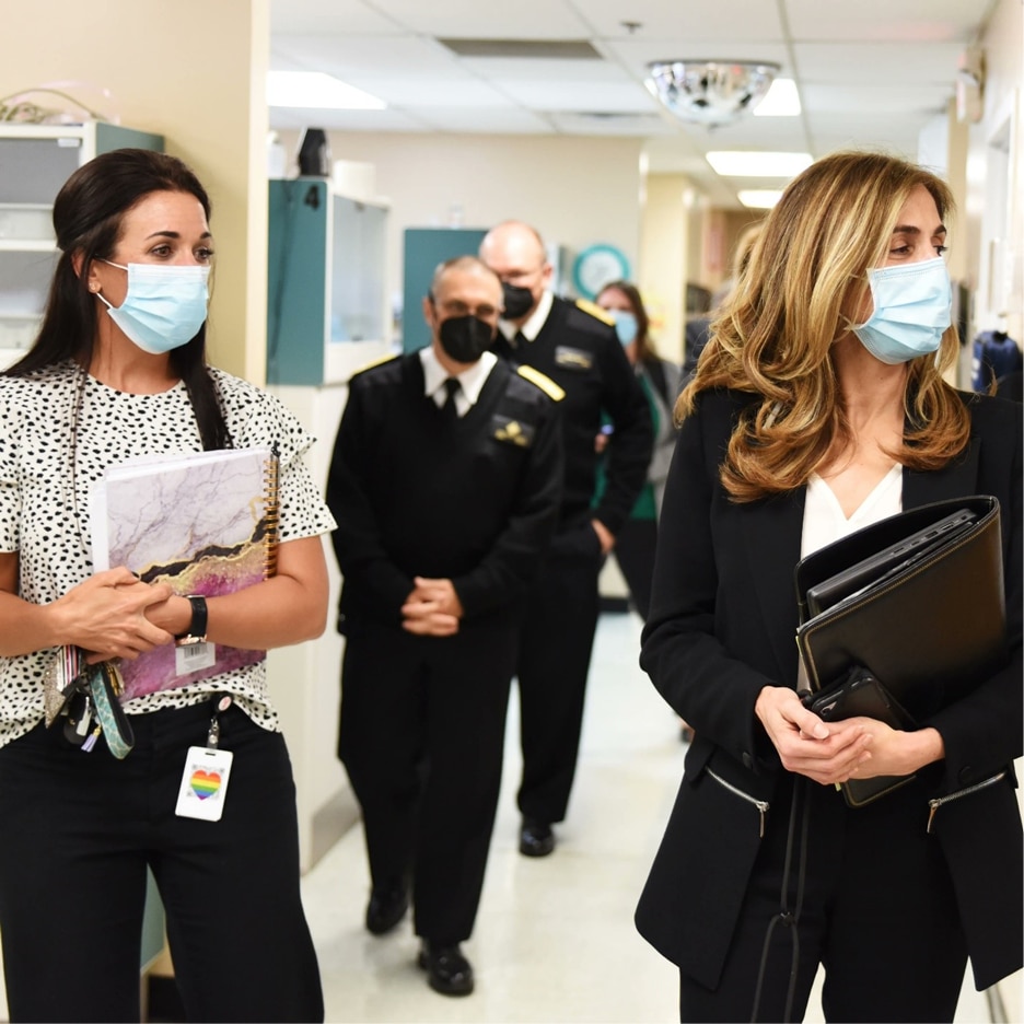 Regional Director Sima Ladjevardian walking in a hallway with others in a medical facility during a visit to Cherokee Nation in Oklahoma.