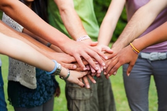 A group of people giving high five to each other.