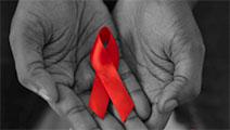 Hands holding red ribbon.