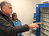 Deputy Secretary Eric Hargan looks at a medicine "vending machine" - thumbnail image
