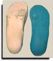 Positive mold with build-ups and orthotic with relief image.